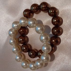 2 faux Pearl bracelets  one cream, the other copper colored.